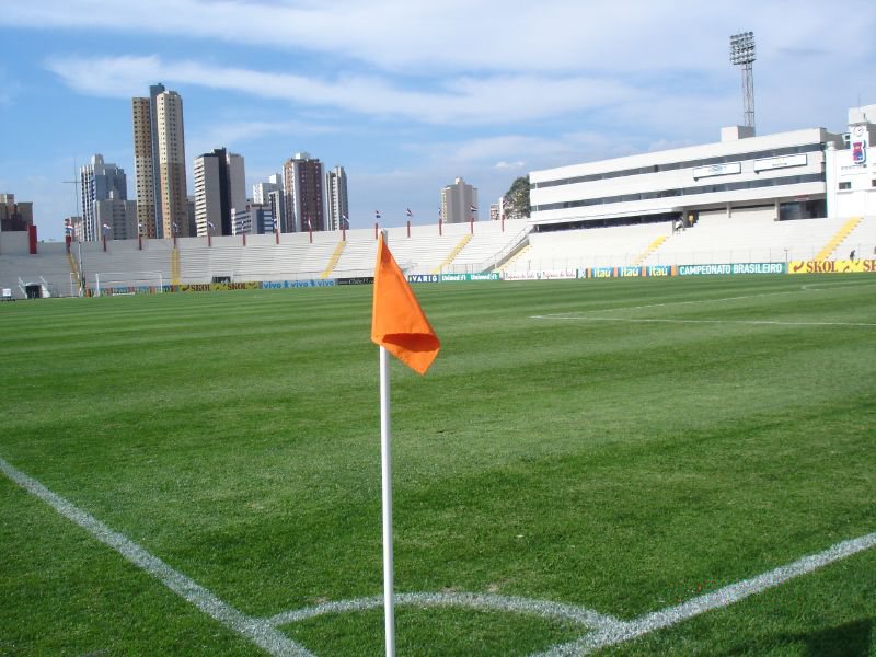 Imagem ilustrativa: Gramado e arquibancada do Estádio Durival de Britto e Silva, a Vila Capanema, com o skyline de Curitiba ao fundo